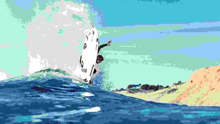 Surfer jumping on waves